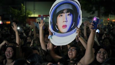 Fans of BTS unable to attend the concert gather outside the Monumental Stadium, Buenos Aires, to listen to Jin perform his single 'The Astronaut' with Coldplay. All photos: AFP