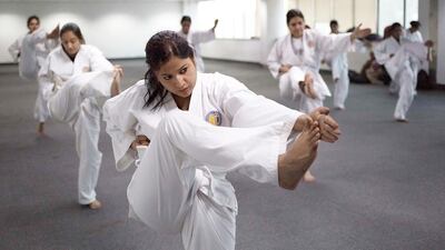 Indian policewomen practise kicks during a self-defence class in New Delhi to rid the city’s streets of sexual predators after rape levels soared in the capital. Rebecca Conway / AFP