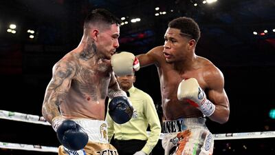 Devin Haney lands a right hook on George Kambosos during their lightweight title bout. AFP