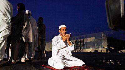 Farmer, Taz Khan, 28, from Quetta, Pakistan offers Maghrib prayers near a farm where one of his friends works between Abu Dhabi and Al Ain.