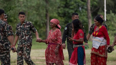 Soldiers assist injured villagers in Trishuli Bazar. EPA