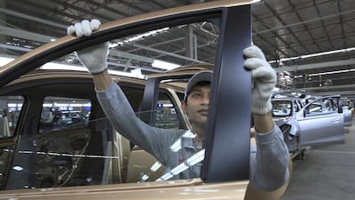 A workers inspects a Datsun Go+ at an assembly line at the Nissan Indonesia factory. Beawiharta / Reuters