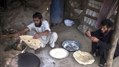A miner cooks roti after finishing his shift at a coal mine in Punjab, where nearly 60 per cent of Pakistan's working children are found. Sara Farid / Reuters