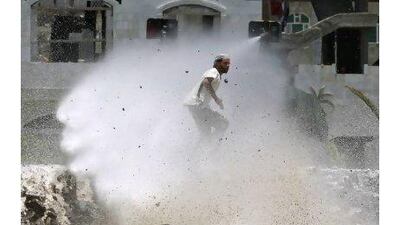 Police use a water cannon to disperse anti-government protesters during a demonstration demanding the ouster of Yemen's President Ali Abdullah Saleh in Taiz Monday.