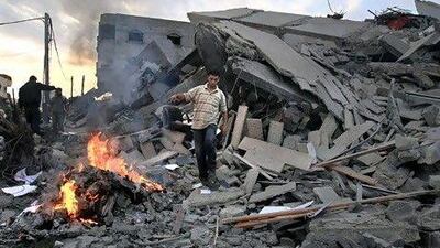 A Hamas security member inspects the destroyed office building of Hamas prime minister Ismail Haniyeh in Gaza City.