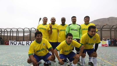 Prisoners, wearing jerseys in the colours of Brazil's national football team, participate in the opening ceremony of their own version of the 2014 World Cup at the Castro-Castro prison in Lima on Monday. Mariana Bazo / Reuters / June 2, 2014