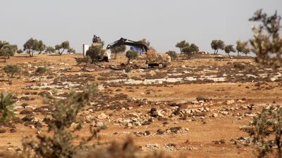This picture was taken on October 14, 2017 showing Turkish army diggers on a hill in the Syrian border town of Salwah. Omar haj kadour / AFP