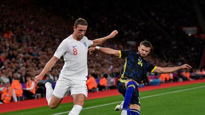 England's Jordan Henderson and Kosovo's Valon Berisha in action. EPA