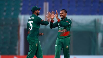 Bangladesh bowler Taijul Islam celebrates with Shakib Al Hasan after taking the wicket of England's Sam Curran for 23. Reuters