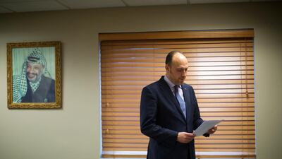 Husam Zomlot, the Palestinian envoy to Washington, reviews papers in Washington. AP