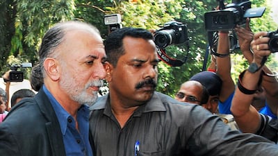 Indian magazine editor, Tarun Tejpal, left, is escorted by police officials from a courthouse after being remanded in police custody in Panaji on December 1, 2013. The editor of Indian news magazine Tehelka was remanded in custody after appearing in court on allegations of sexually assaulting a colleague in a hotel in the holiday state of Goa. A court in Goa ordered Tejpal remain in custody to allow police time to question the 50-year-old editor, who faces a possible rape charge over the allegations that could see him in jail for 10 years.