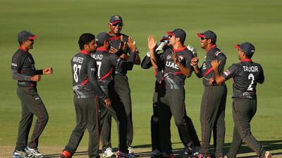 The UAE cricket team celebrate a wicket against India at the Cricket World Cup last year. Paul Kane / Getty Images