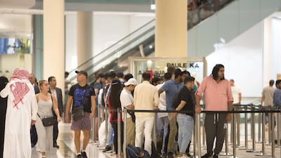 People wait in a queue to purchase the new iPhone XS at the Apple store in Dubai Mall, 12 hours before it goes on sale. Leslie Pableo / The National