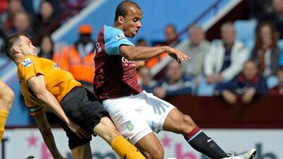 Aston Villa's Gabriel Agbonlahor, right, shoots under pressure from Roger Johnson.