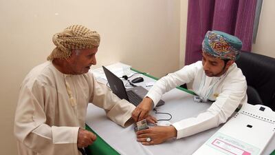 An Omani man has his finger stained with ink after casting his ballot at a polling station in Al Suwayq, in northeastern Oman, in nationwide municipal elections on December 25, 2016. Mohammed Mahjoub / AFP
