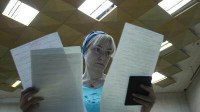 A woman studies her ballot paper during voting in a presidential election at a Kiev polling station on May 25, 2014. David Mdzinarishvili/Reuters