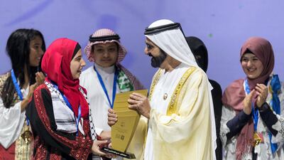 Sheikh Mohammed bin Rashid, Vice President of the United Arab Emirates and Ruler of Dubai, awards Afaf Sharef, 17, from Palestine the trophy for winning the Arab Reading Challenge / Christopher Pike / The National