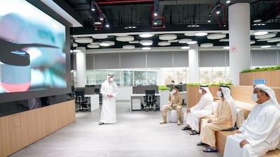 Sheikh Mohammed attends a presentation during the visit.