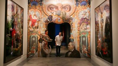 A gallery assistant poses next to an artwork entitled "The King of Pop" by US artist Mark Ryden, on display during a photocall to promote the exhibition:"Michael Jackson: On the Wall" at the National Portrait Gallery in London, Britain, on June 27, 2018. Daniel Leal-Olivas / AFP