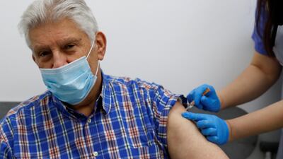 File photo. A person receives a dose of the Oxford/AstraZeneca COVID-19 vaccine at Cullimore Chemist, in Edgware, London. Reuters