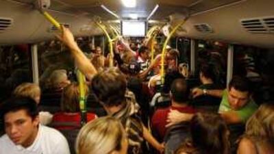 People ride a bus heading to designated parking lots after the Grand Prix race yesterday.