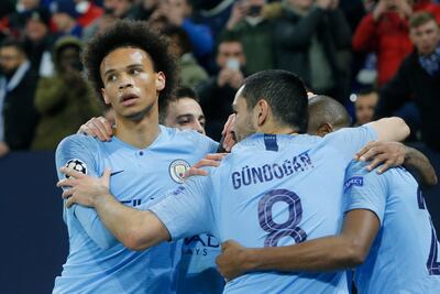 Manchester city players celebrate their third goal with midfielder Leroy Sane, left, during the first leg, round of sixteen, Champions League soccer match between Schalke 04 and Manchester City at Veltins Arena in Gelsenkirchen, Germany, Wednesday Feb. 20, 2019. (AP Photo/Michael Probst)