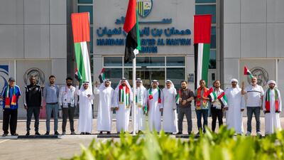 Al Dhafra Club executive management and staff celebrate UAE flag day at the entrance to Hamdan bin Zayed Stadium in Zayed City, Al Dhafra region. Twitter/AlDhafra