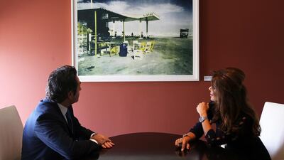 Art work by Shirana Shahbazi on display at the Julius Baer office in DIFC Gate Village in Dubai. Jean Pierre Dib, left, and Nada Al Yazdi, right, admire the art. Pawan Singh / The National
