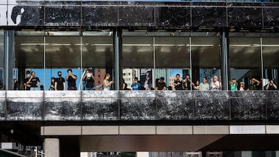 Onlookers watch and take photos of the annual pro-democracy rally. Bloomberg