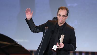 Mexican Director Jorge Cuchi holds the Naguib Mahfouz Award for Best Screenplay for the film '50 or Two Whales Meet on the Beach' during the closing ceremony of the 42nd Cairo International Film Festival (CIFF). EPA