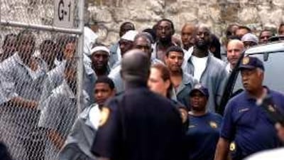 Officers stand watch over a crowd of inmates at the Metropolitan Transition Center in east Baltimore. Monica Lopossay,