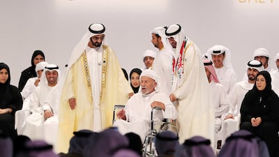 Sheikh Mohammed bin Rashid and Sheikh Mohamed bin Zayed award Saif Al Mansoori from Abu Dhabi with the UAE Pioneers Award for charitable work, in November 2017. Pawan Singh / The National