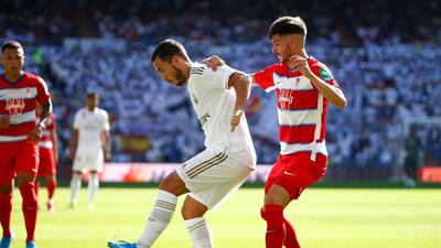 Real Madrid's Eden Hazard, left in action with Granada's Carlos Neva. Reuters