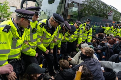 Police recently scuffled with protesters in south London who were blocking a bus being used to transport migrants. Getty Images