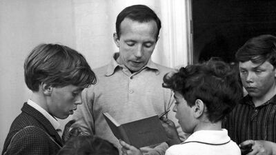 Nobby Stiles, the England soccer player, signs autographs for young fans outside the England team's hotel in Hendon, London. AP