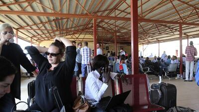 Locals and foreign nationals gather at Juba International Airport as they wait for flights out of the South Sudanese capital. REUTERS/Hakim George