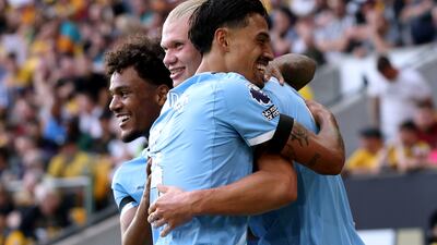 Erling Haaland of Manchester City celebrates scoring his team's third goal against Wolves with teammates Tijjani Reijnders and Oscar Bobb. Getty Images