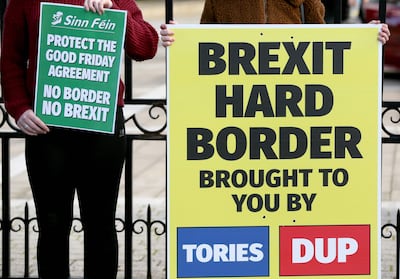 Students hold up Sinn Fein anti-Brexit placards during a rally in Belfast in 2018. AFP