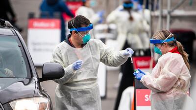 Medical staff and volunteers from Children's National Hospital test children, who arrived with a doctors referral, for the coronavirus at a drive-thru test site in Washington, DC. EPA