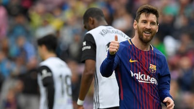 Lionel Messi give the thumbs up as Barcelona stretched their unbeaten run in La Liga to 39 games, a Spanish record, with a 2-1 win over Valencia. Lluis Gene / AFP