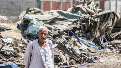 A man stands by the wreckage of a fatal rail collision on the outskirts of Egypt's Mediterranean city of Alexandria, on August 12, 2017. AFP