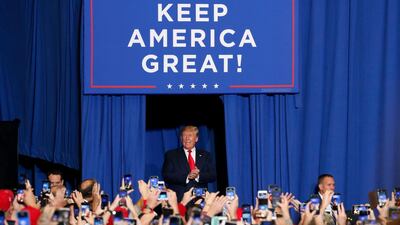 President Donald Trump pauses under the Keep America Great banner before speaking on a number of topics including the successes of his administration and making fun of his critics a rally in Tupelo, Miss. days before the Nov. 5 general elections in Mississippi. AP