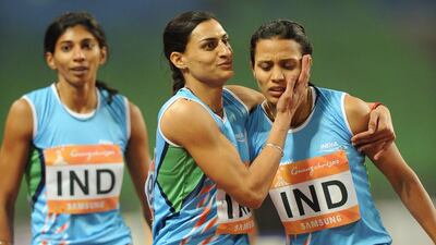 Mandeep Kaur, right, is congratulated after finishing first for India in the women’s 4x400m relay final at the 2010 Asian Games in Guangzhou. The country is debating sending only potential medal winners to the 2014 Games at Incheon, South Korea. Philippe Lopez / AFP