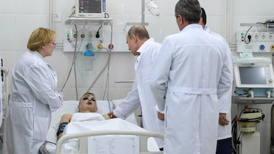 Russian President Vladimir Putin visits a boy, injured during a fire in a multi-story shopping center at a hospital in the Siberian city of Kemerovo, about 3,000 kilometers east of Moscow. Alexei Druzhinin, Sputnik, Kremlin Pool Photo / via AP