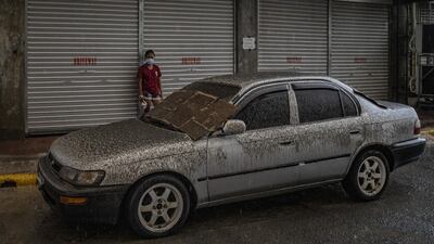 A vehicle covered in ash mixed with rainwater. Getty Images