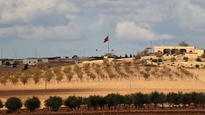 A general view shows a Turkish flag is flying at a military post in the countryside village of Ashma in the Kurdish city of Kobane in northern Syria. AFP