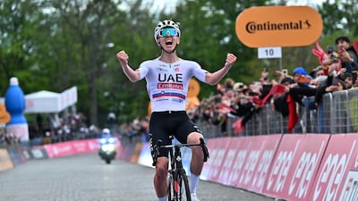 Tadej Pogacar of UAE Team Emirates celebrates after crossing the finish line to win Stage 2. EPA