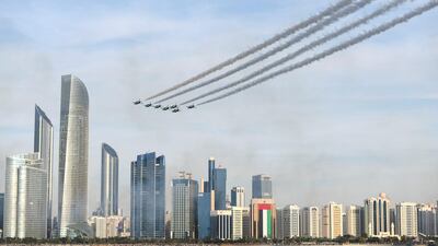 The Al Fursan aerobatic team light up the skyline of Abu Dhabi. Khushnum Bhandari / The National