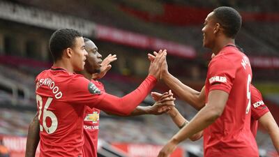 Manchester United's Mason Greenwood celebrates scoring their fourth goal with Aaron Wan-Bissaka and Anthony Martial. Reuters