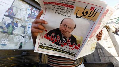 A Yemeni reads a local newspaper on February 22, 2015, the day after president Abdrabu Mansur Hadi escaped from house arrest in Sanaa, Yemen. Yahya Arhab/EPA